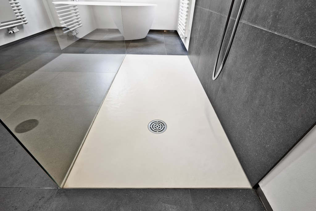 Corian floor and drain from modern shower in luxury bathroom